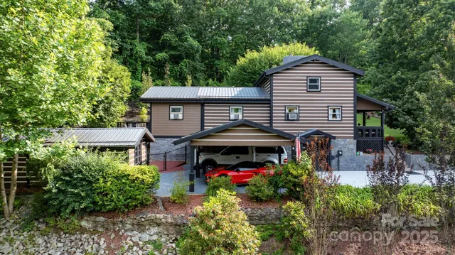 a front view of a house with yard and trees