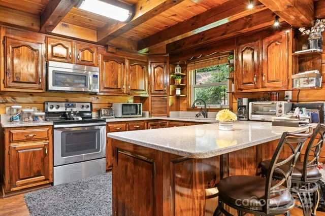 a kitchen with a stove a sink and cabinets