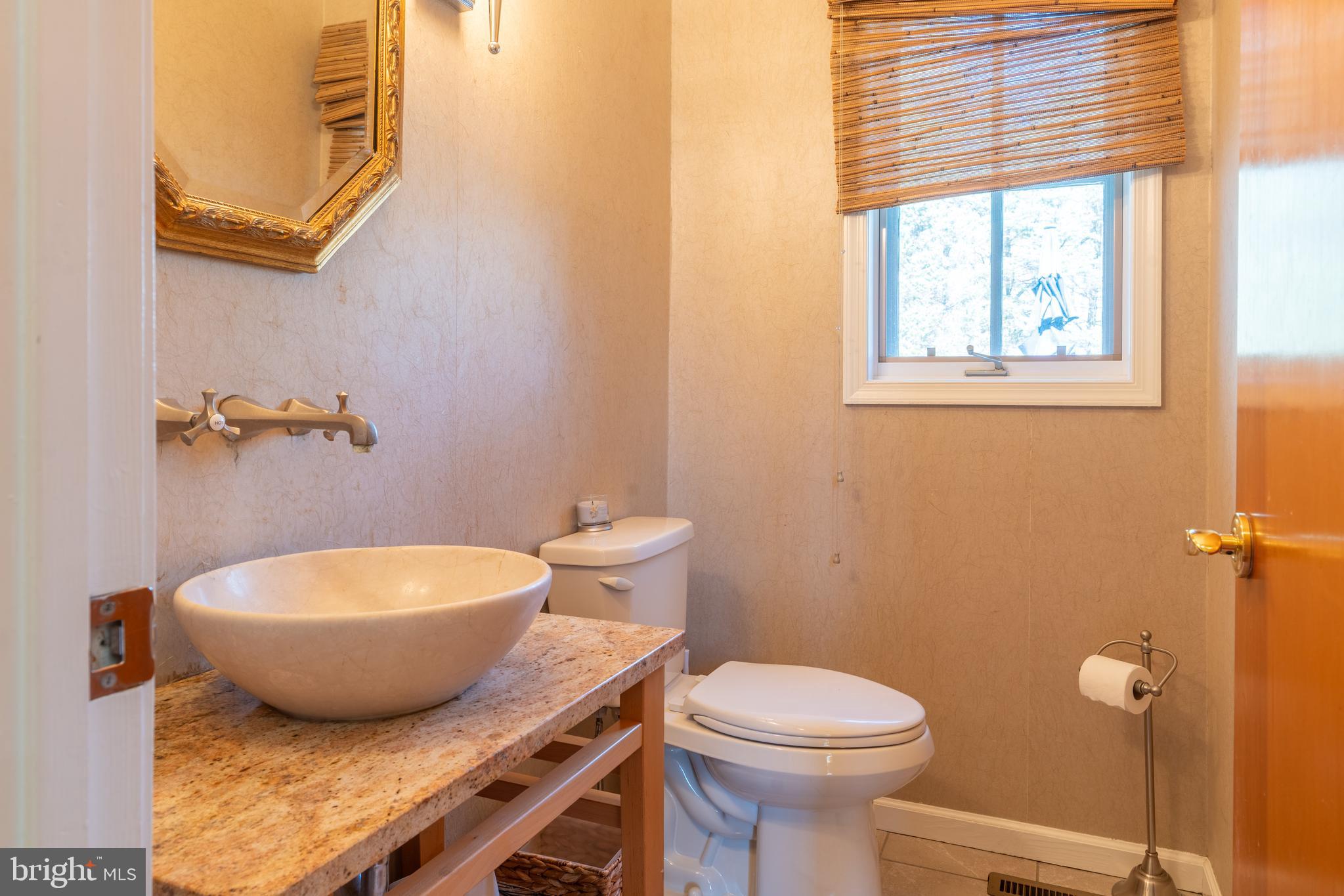 925 Morgan Road Jenkintown, PA 19046 - Photo 32 of 83 a bathroom with a granite countertop toilet a sink and a window