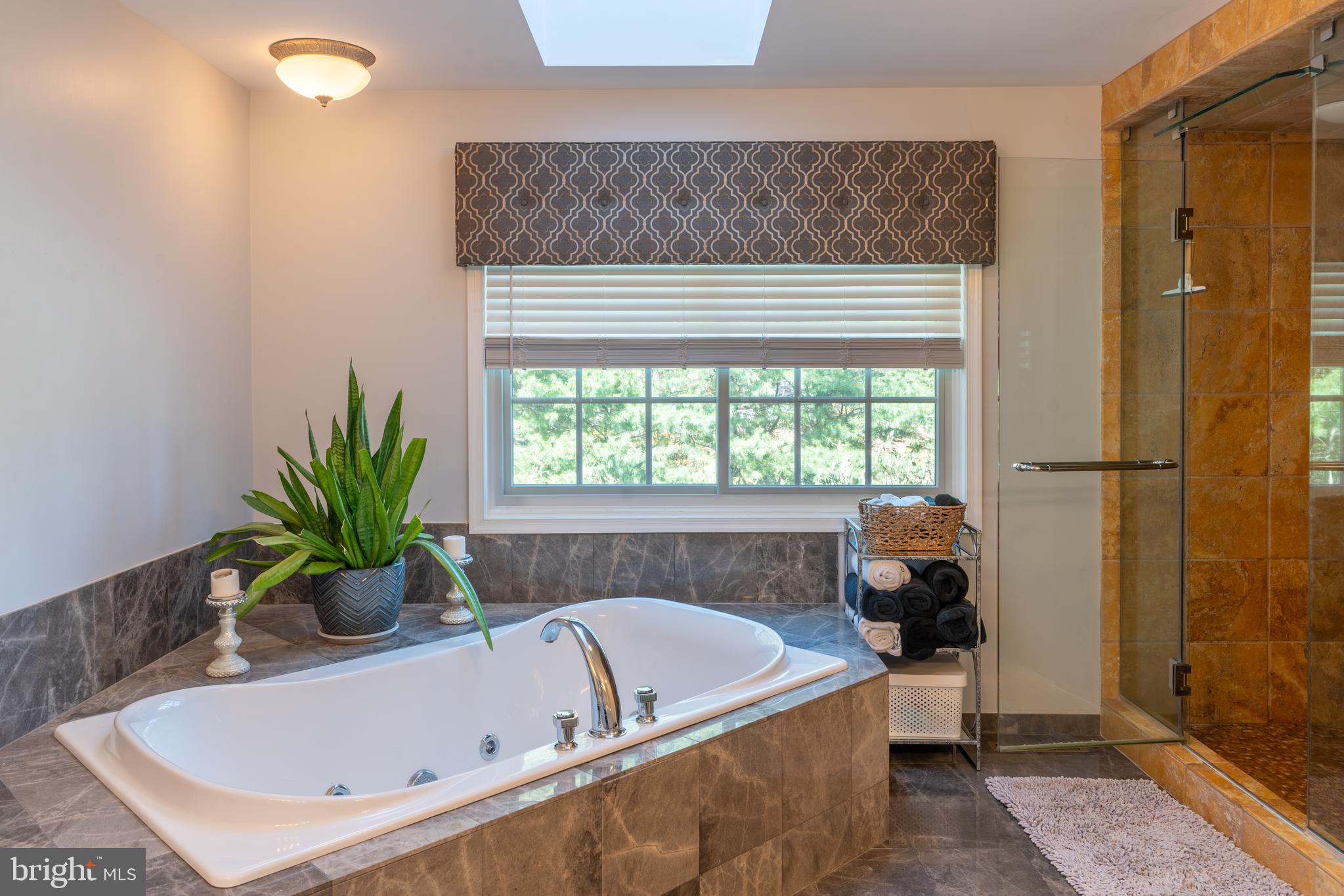 925 Morgan Road Jenkintown, PA 19046 - Photo 57 of 83 a bath tub sitting in a bathroom next to a window