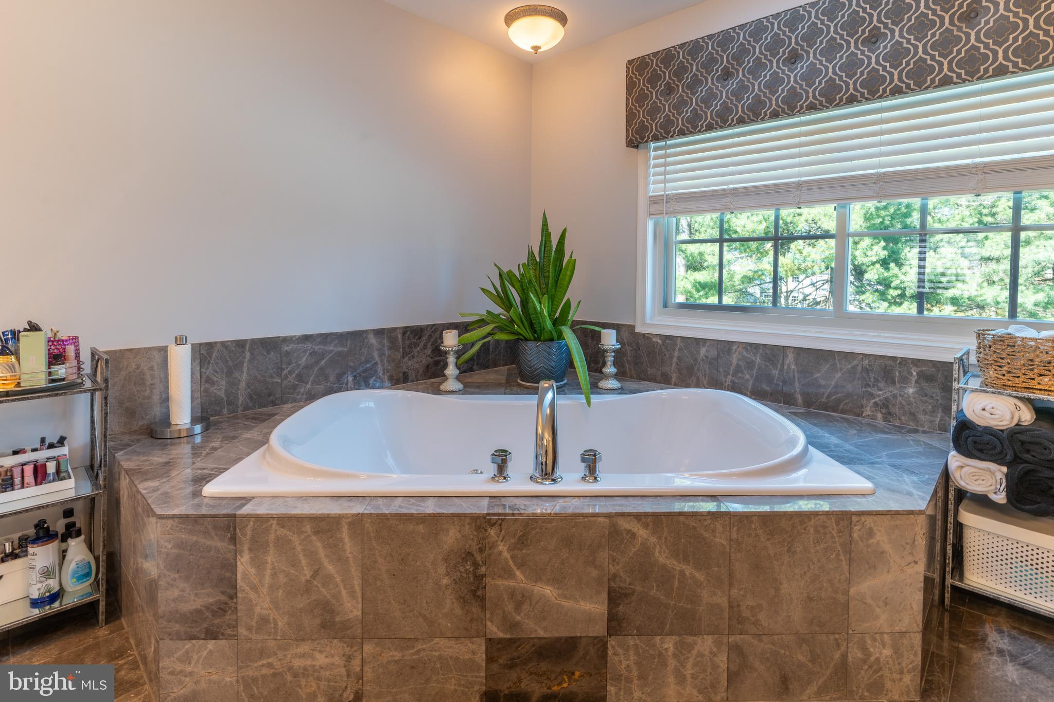 925 Morgan Road Jenkintown, PA 19046 - Photo 58 of 83 a white bath tub sitting in a bathroom next to a window