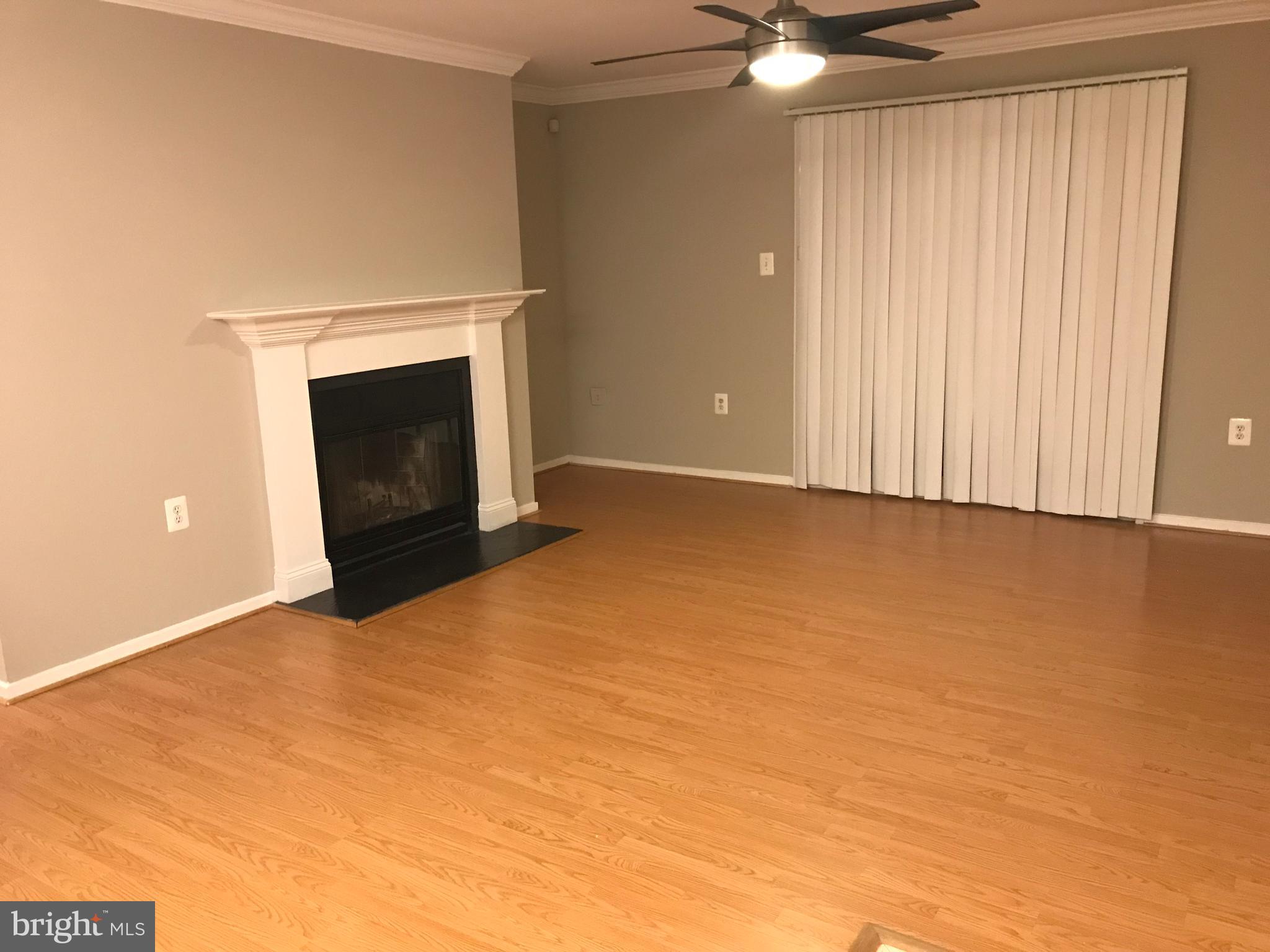 7702 Lexton Place, Unit 65 Springfield, VA 22152 - Photo 5 of 24 a view of an empty room with a fireplace and a window