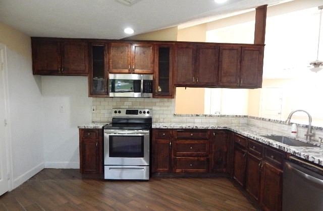 6402 Brookgate Drive Spring, TX 77373 - Photo 3 of 17 a kitchen with a sink stove and microwave