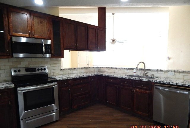 6402 Brookgate Drive Spring, TX 77373 - Photo 4 of 17 a kitchen with granite countertop a sink and a stove