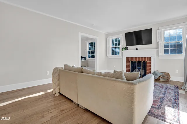 a living room with furniture a fireplace and a flat screen tv