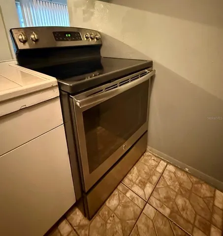 a utility room with wooden floor washer and dryer