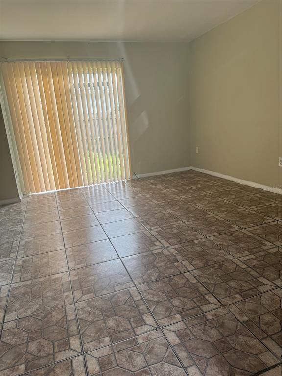 1019 West Sumner Street Kissimmee, FL 34741 - Photo 5 of 12 a view of an empty room and window