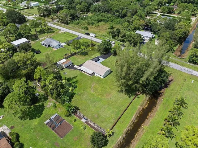 an aerial view of residential houses with outdoor space and street view
