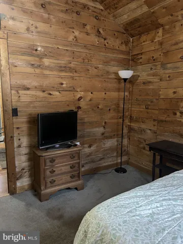 a bedroom with a bed and a television in it