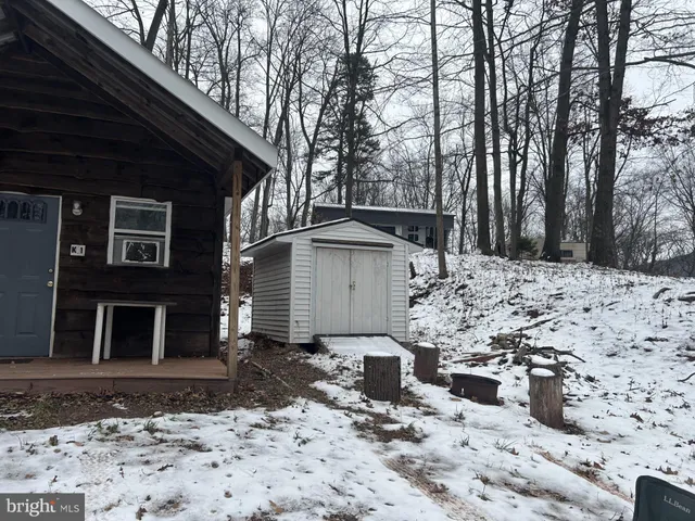 a view of a house with a yard covered in snow