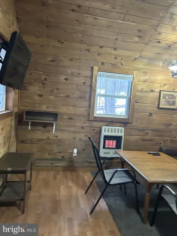 a living room with furniture a rug and a wall painting