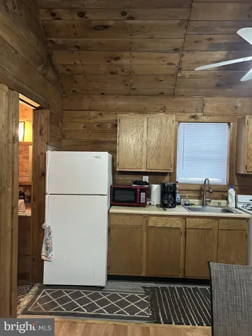 a utility room with stainless steel appliances wooden floor