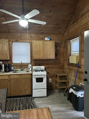 a kitchen with a sink a stove and cabinets