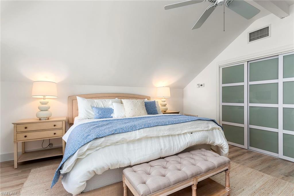 143 Useppa Island Bokeelia, FL 33922 - Photo 12 of 22 Bedroom with light wood finished floors and ceiling fan