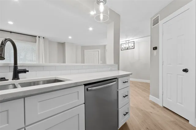 a kitchen with a sink and cabinets