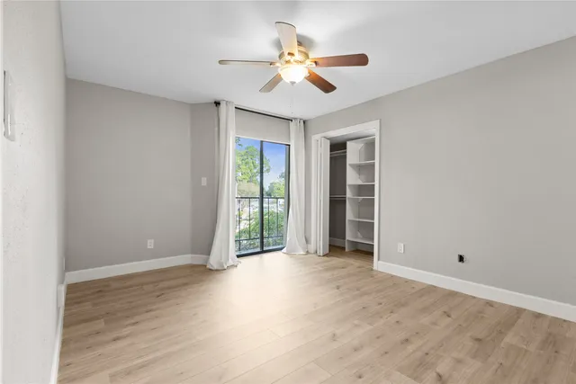 a view of an empty room and wooden floor
