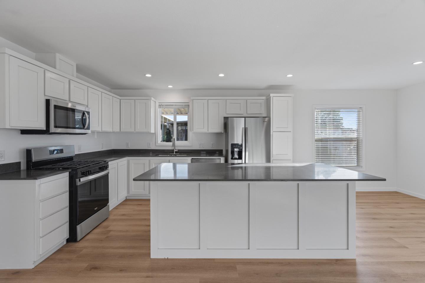 144 Holm Road, Unit 120 Watsonville, CA 95076 - Photo 14 of 25 a large kitchen with a center island and stainless steel appliances