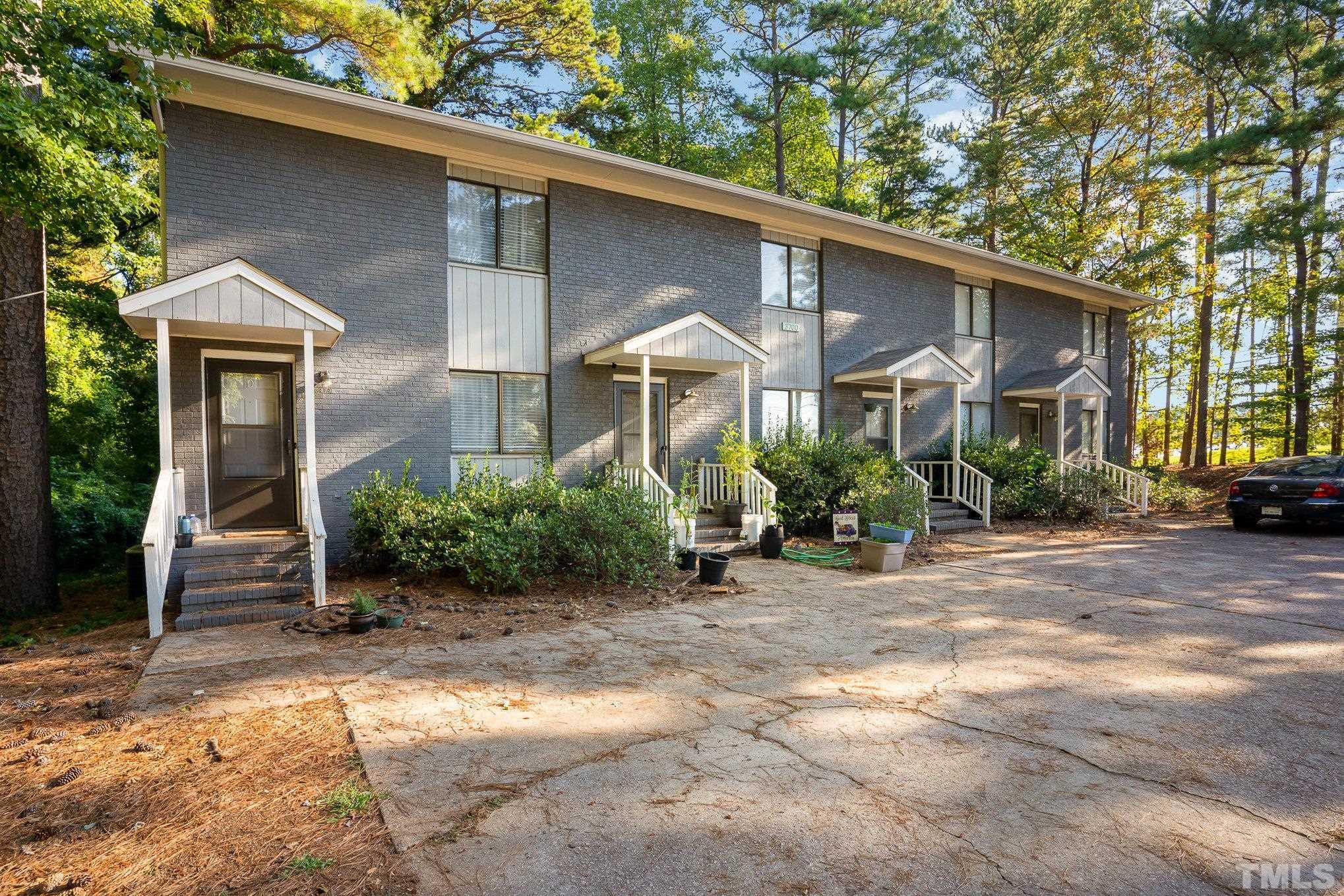 a front view of a house with yard and glass windows