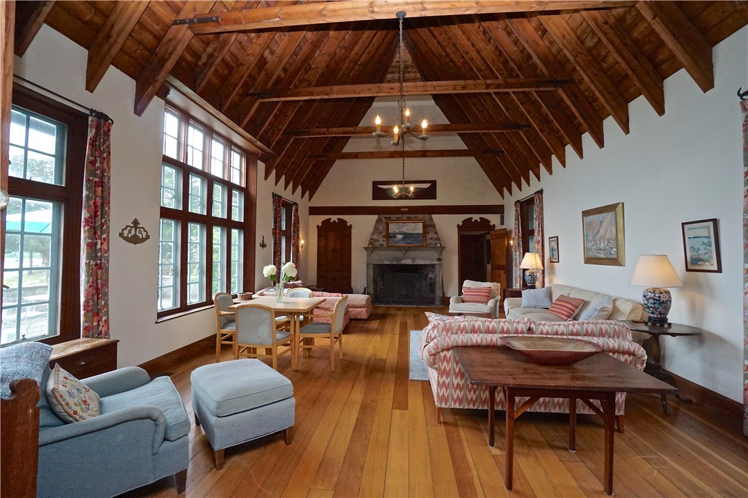216 Highland Drive Jamestown, RI 02835 - Photo 7 of 39 The central pavilion features a grand fireplace, with vaulted ceilings.