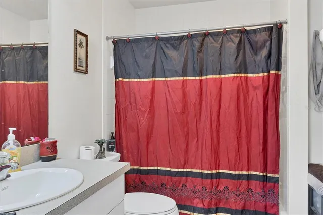 a bathroom with a sink a toilet and mirror