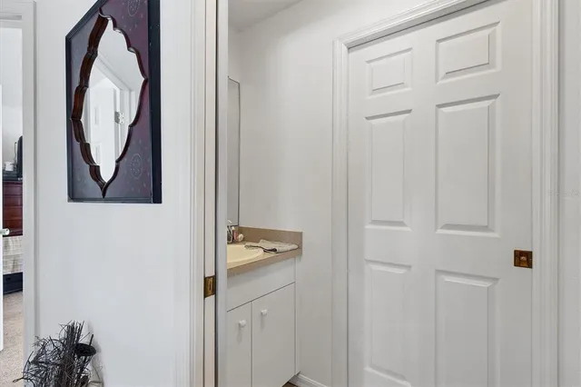 a view of a bathroom with a sink and a mirror