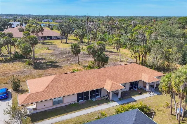 an aerial view of a house with a yard