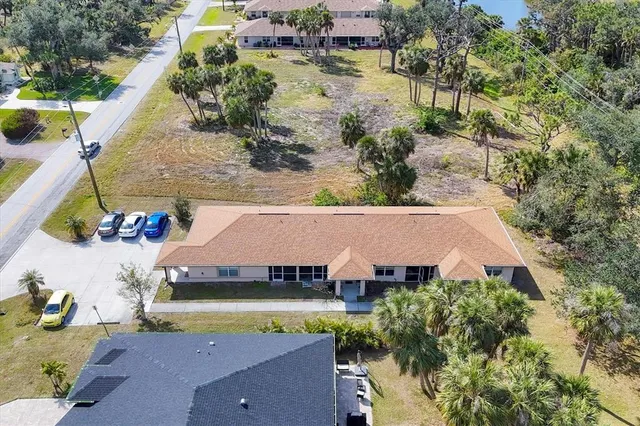 an aerial view of a house with swimming pool and outdoor seating