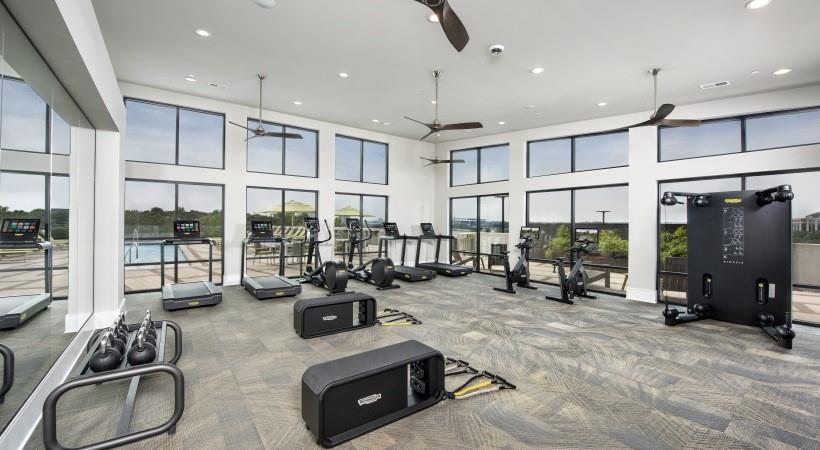 2180 Shadowood Parkway, Unit 434 Atlanta, GA 30339 - Photo 22 of 28 a room with gym equipment and large windows