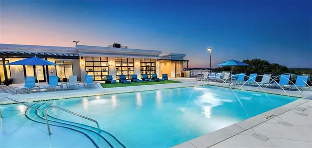 a view of a swimming pool and outdoor seating