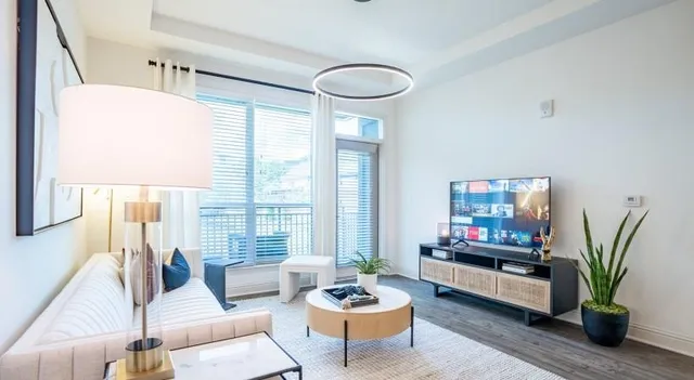 a living room with furniture potted plant and a window