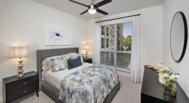 a bedroom with a bed and a window