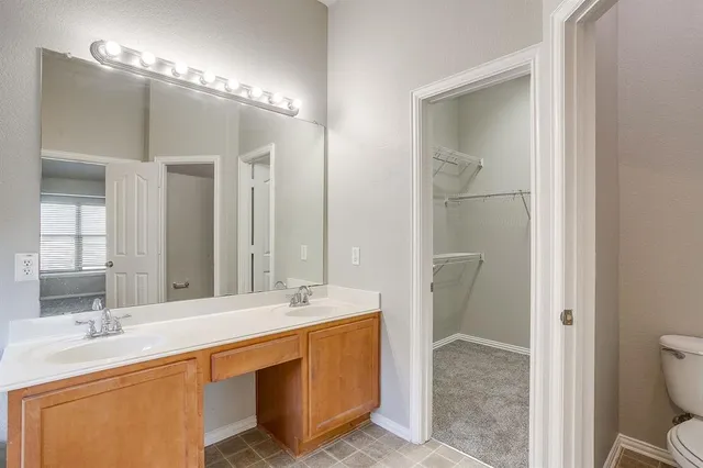 a bathroom with a sink double vanity and a mirror