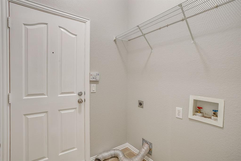 928 Remington Ranch Road Mansfield, TX 76063 - Photo 18 of 20 a view of a room with racks on the wall