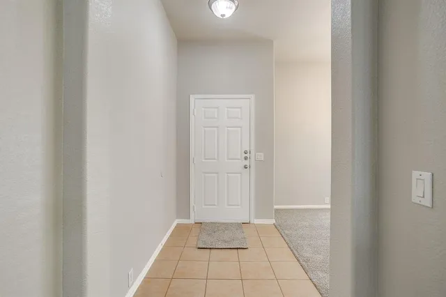a view of an empty room and closet area