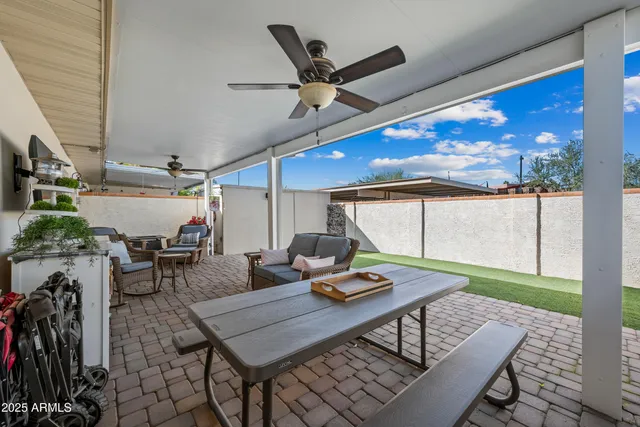 a view of a patio with a dining table and chairs