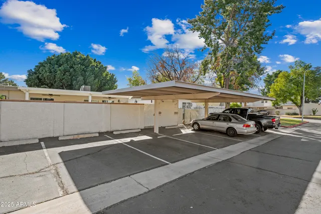 a view of a cars park in front of a building