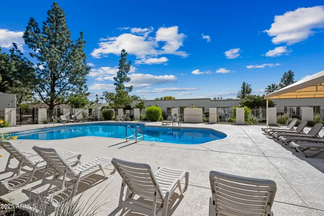 a view of a swimming pool with an outdoor seating