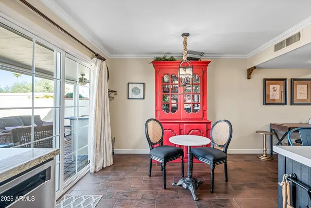 a dining room with furniture a chandelier and wooden floor