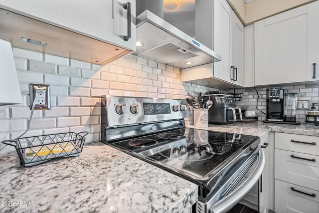 a stove top oven sitting inside of a kitchen