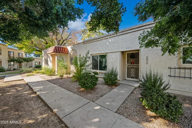 a front view of a house with garden