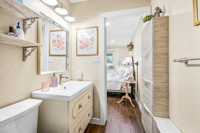 a kitchen with stainless steel appliances granite countertop a sink and a wooden floor
