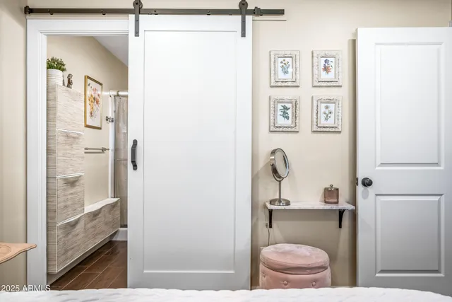 a bedroom with a large bed and a chandelier