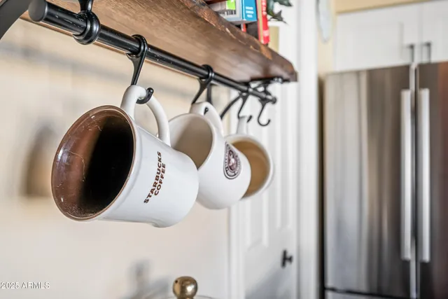 a kitchen with granite countertop stainless steel appliances a sink and white cabinets