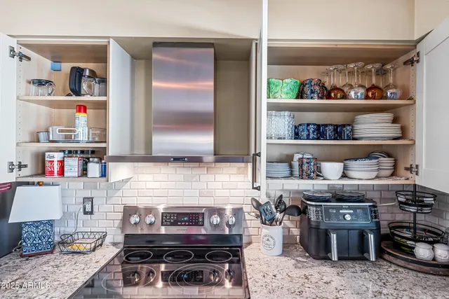 a kitchen with a table chairs refrigerator and cabinets