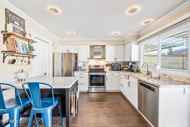 a kitchen with stainless steel appliances granite countertop a stove and a sink