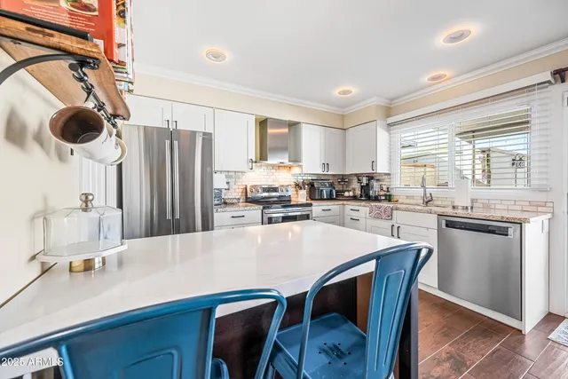 a view of a dining room with furniture and a rug