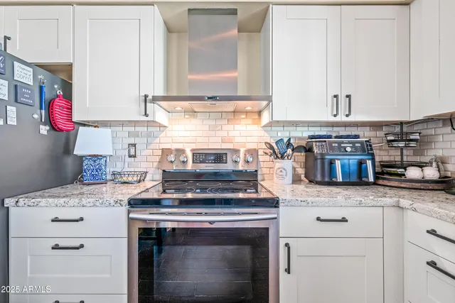 a room with granite countertop a sink and a large window