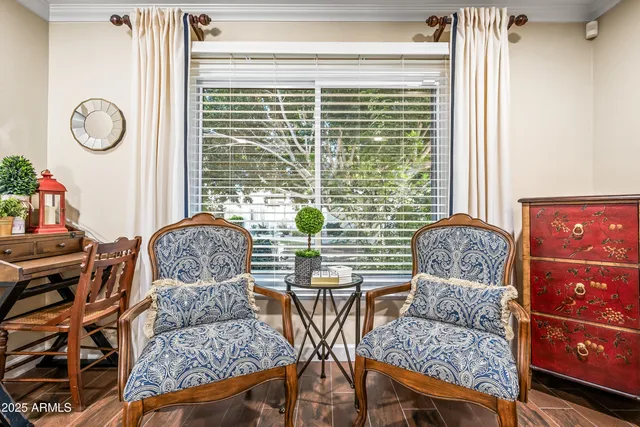 a living room with patio furniture and a wooden floor