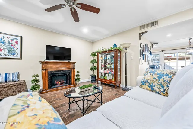 a living room with furniture a fireplace and a flat screen tv