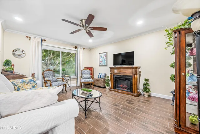 a living room with furniture a fireplace and a flat screen tv